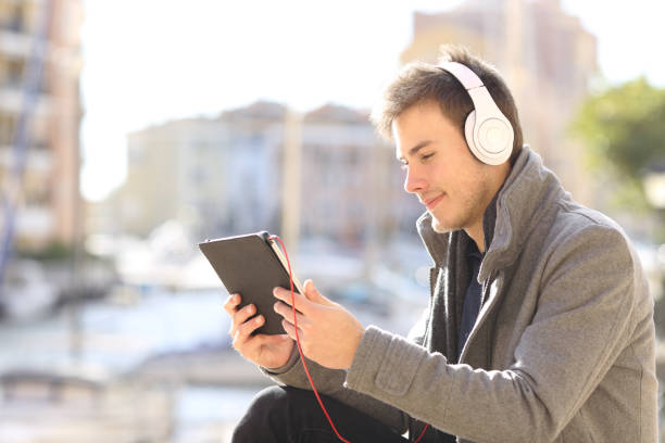 istock Serious man watching and listening media on a tablet 1092626736