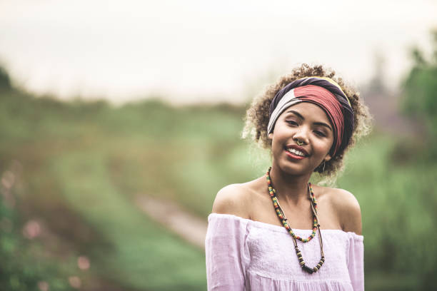 Portrait of a young woman with afro hairstyle in the city at sunset
