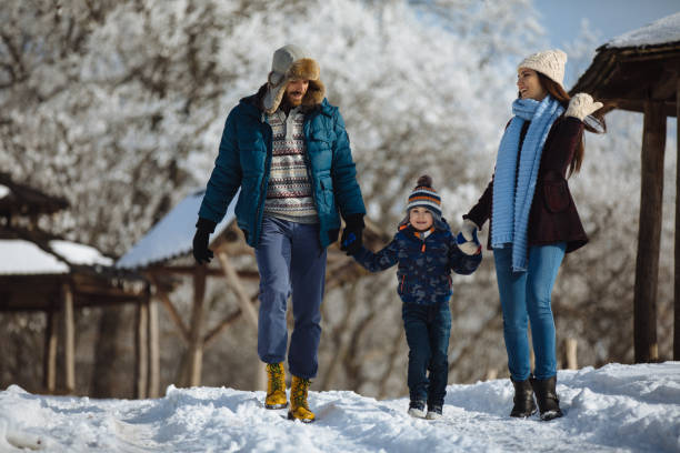 istock Family enjoying winter walk in forest 1092630798