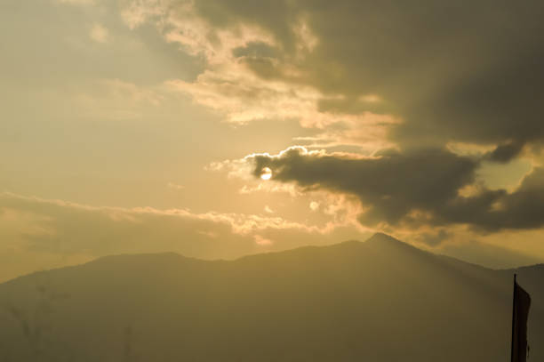 istock sky with clouds and sun. Storm clouds and orang sky. Sunlight rays in reflects clouds. Beautiful aerial view above clouds with sunset. Nature wallpaper background. 1092632474