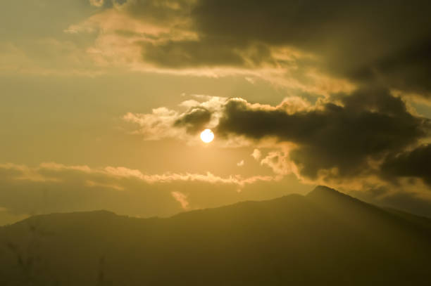 istock sky with clouds and sun. Storm clouds and orang sky. Sunlight rays in reflects clouds. Beautiful light orange sky and white cloudy with sunshine. Color shade of nature background. 1092632532
