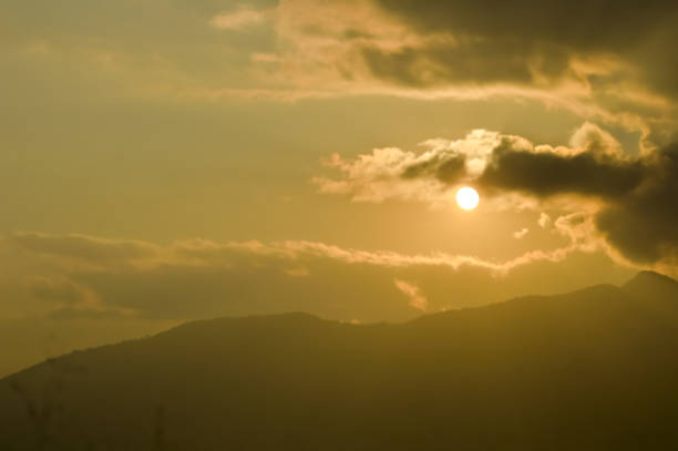 istock sky with clouds and sun. Storm clouds and orang sky. Sunlight rays in reflects clouds. Looking up view of panorama. Nature wallpaper background. 1092632582