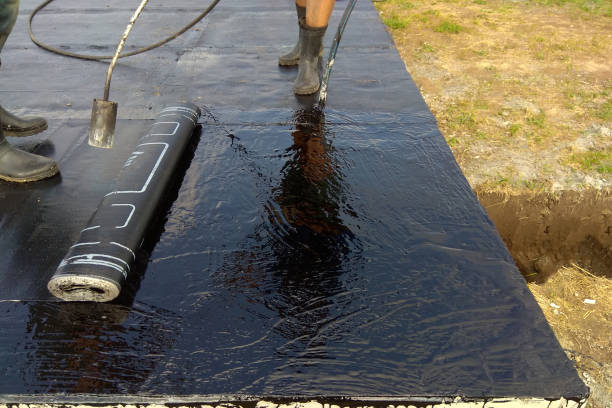 istock Professional installation of waterproofing on the concrete foundation Two worker at construction site. 1092635806