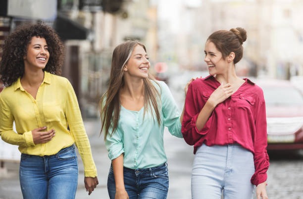istock Three happy women walking in the city 1092636320