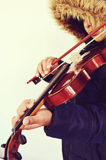 istock Vertical capture of a boy playing the stringed and bowed musical instrument, the violin 1092640406