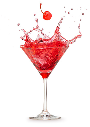 cherry falling into a splashing red cocktail isolated on white