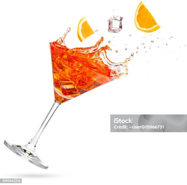 Orange Slices Falling Into A Tilted Splashing Cocktail Stock Photo - Download Image Now
