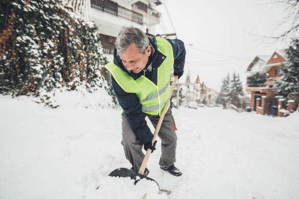 istock Mature guy cleaning snow with snow shovel 1092642872