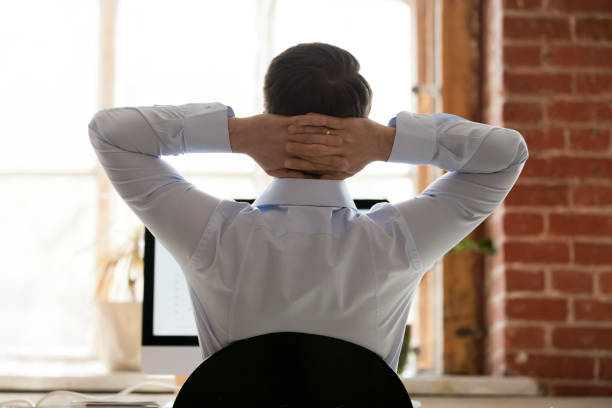 istock Relaxing businessman stretching with hands behind head 1092645768