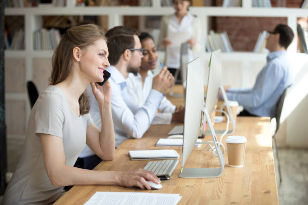 istock Confident employee talking by phone with client, customer 1092645828
