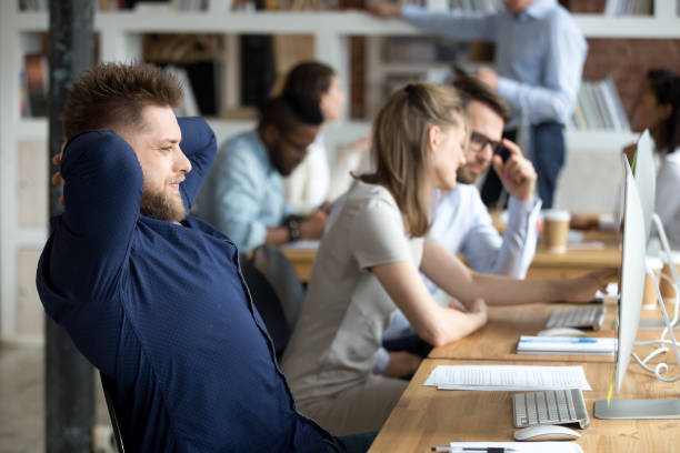 istock Smiling businessman relaxing leaning back in office chair 1092645838