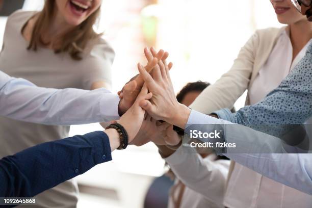 Excited Multiracial Team Giving High Five At Briefing Close Up Stock Photo - Download Image Now