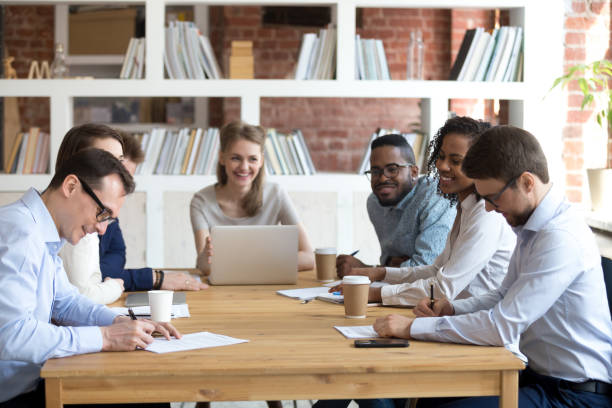 istock Partners signing contracts at group multiracial meeting 1092645954