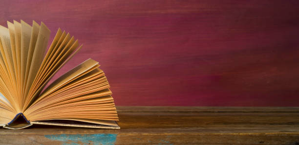istock open book on red grungy background, good copy space 1092649330