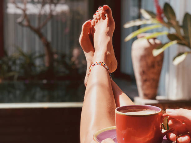 istock Beautiful woman drinking coffee while sitting near swimming pool. 1092651410