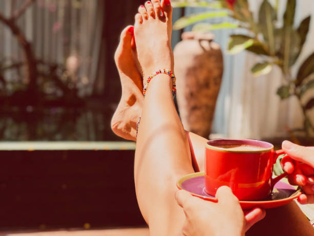 istock Beautiful woman drinking coffee while sitting near swimming pool. 1092652110