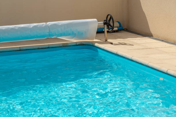 istock Pool cover on the edge of a pool during the summer 1092655324
