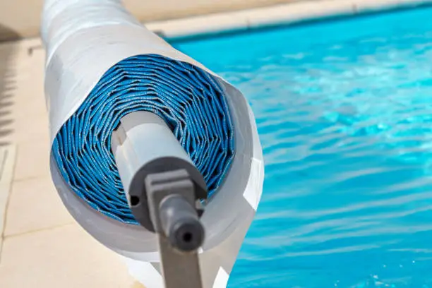 Photo of Pool cover on the edge of a pool during the summer