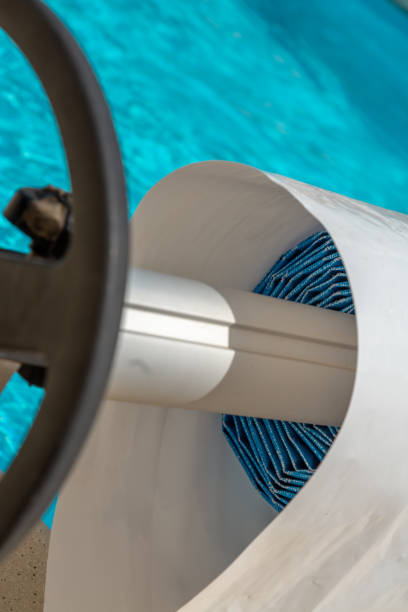 istock Pool cover on the edge of a pool during the summer 1092655452