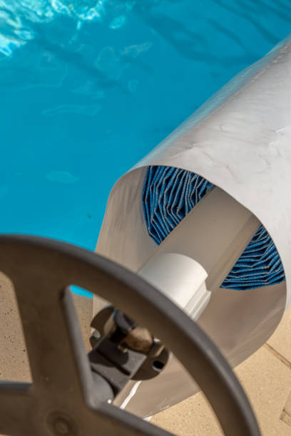 istock Pool cover on the edge of a pool during the summer 1092655456
