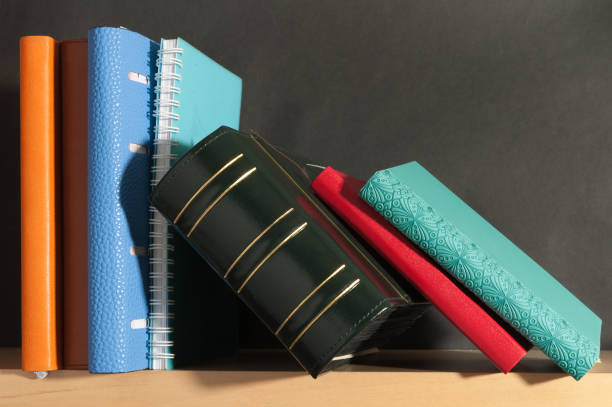 notebook diary on black background on the bookshelf