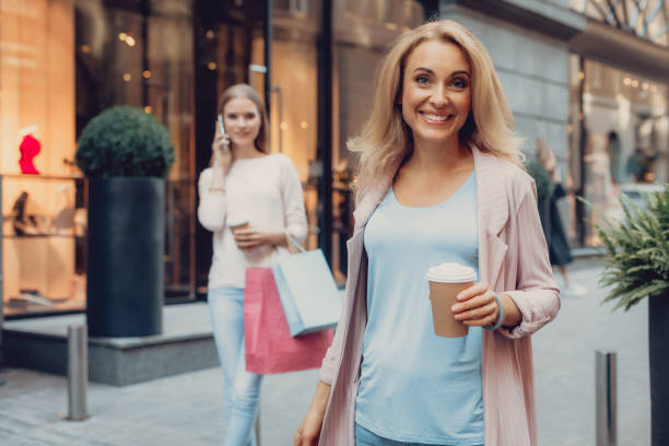 istock Charming lady standing on the street while her daughter talking on cellphone 1092665872