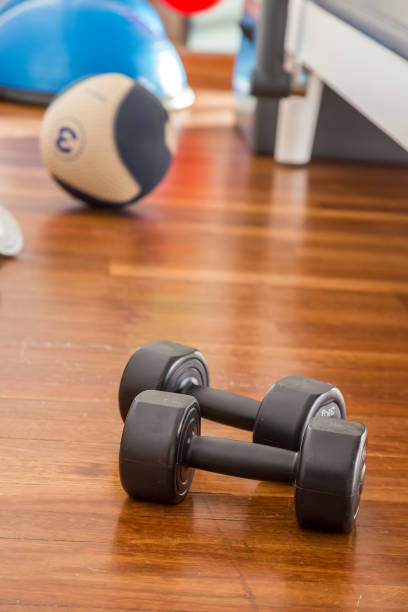 istock Sport Training Weight Dumbles on Wooden Ground 1092670850