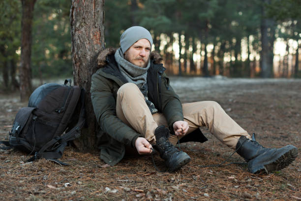 istock Pensive hipster guy wanderlust with touristic backpack enjoy tranquility during exploring nature environment, 1092671070