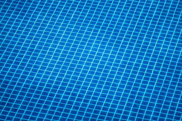 istock Looking into blue tiled Swimming pool rippled water 1092673720