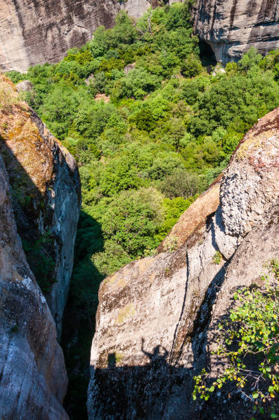 istock Scenic landscape view on a green overgrown valley under the Meteora rock formations cliffs and peaks in Greece 1092677572