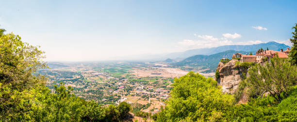 istock Panoramic view on scenic Meteora landscape rock formations with Saint Stephen Nunnery Monastery on the cliff and Kalabaka town just above the mountain 1092679918