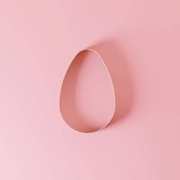 Photo of Minimal easter concept: paper egg on pink background.