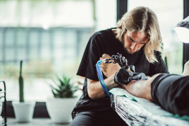 istock Artist tattooing a man's leg 1092688160