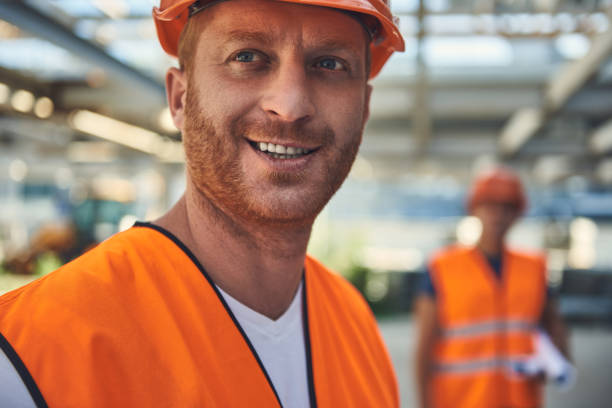 istock Workers in helmets are locating at the construction site 1092688516