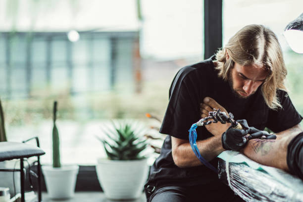 istock Man tattoo artist working hard 1092689234