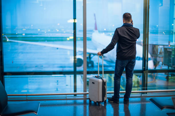 istock Man Talking on Cell Phone at the Airport 1092689368