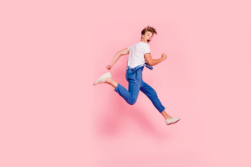 Sprint energy people he him person concept. Side profile full length body size studio photo portrait of handsome delightful charming cool trend swag boy teenager isolated pastel background copyspace