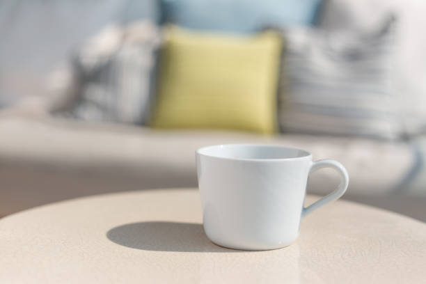 istock White ceramic coffee cup on white ceramic table, outdoor on sunny day with cup's shadow on table 1092689888