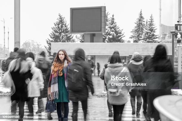 Woman Standing Out From The Crowd Stock Photo - Download Image Now - Standing Out From The Crowd, Crowd of People, Women