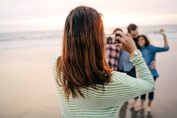istock Family on the beach taking photos 1092691412
