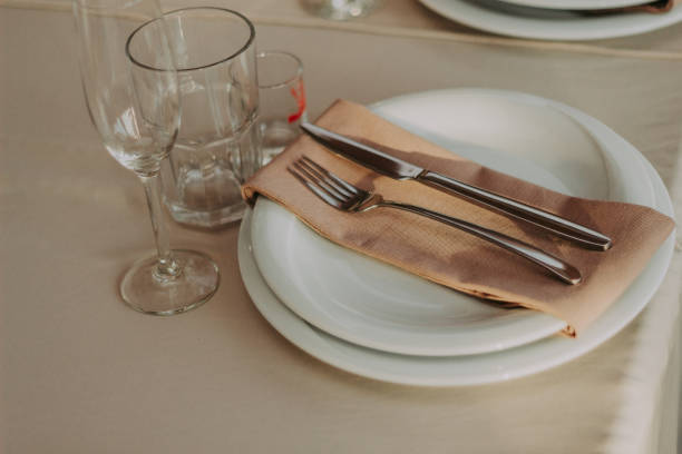 istock Glass dishes on a table on a white tablecloth. clean and empty. lovely, chic restaurant. cozy atmosphere. 1092694096