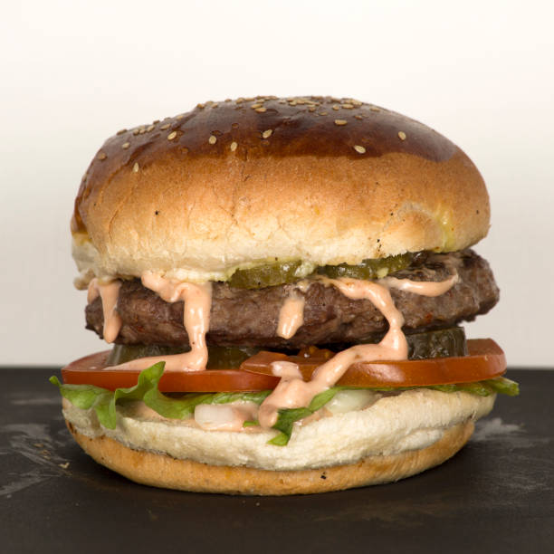istock a delicious hamburger with cheese and pickles 1092694604
