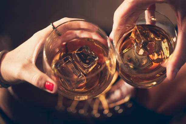 istock A couple toasting with whiskey in a bar 1092697240