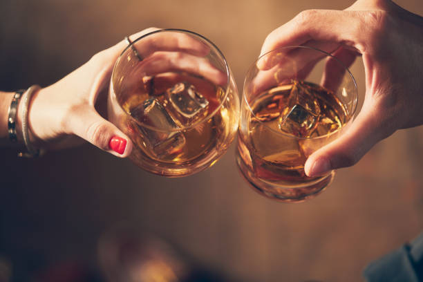 istock A couple makes a toast with whiskey 1092697250