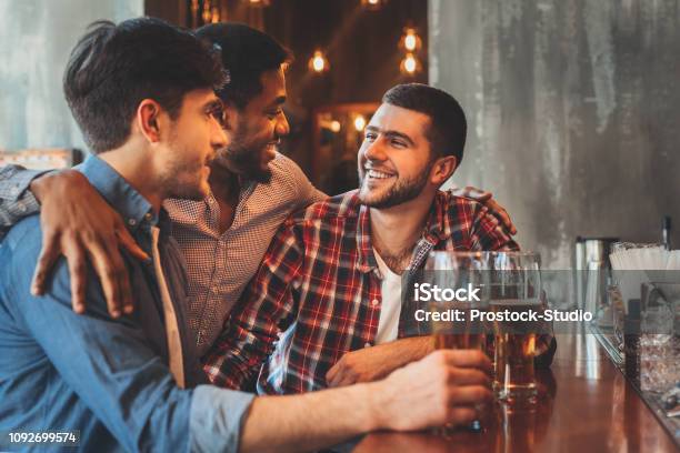 Old Friends Drinking Beer And Talking In Pub Stock Photo - Download Image Now - Pub, Friendship, Bar - Drink Establishment