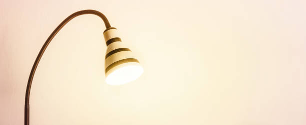 istock Luminous striped lamp. White wall for mock up or copy space 1092699724