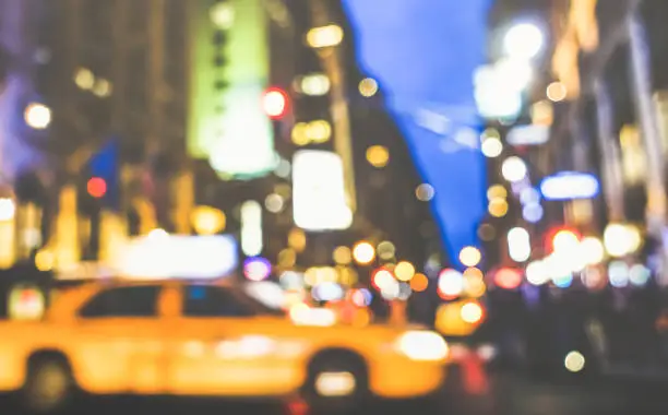 New York City abstract rush hour - Defocused yellow taxicab car and traffic jam on 5th avenue in Manhattan downtown at blue hour - Blurred bokeh postcard on retro vintage nostalgic filtered look