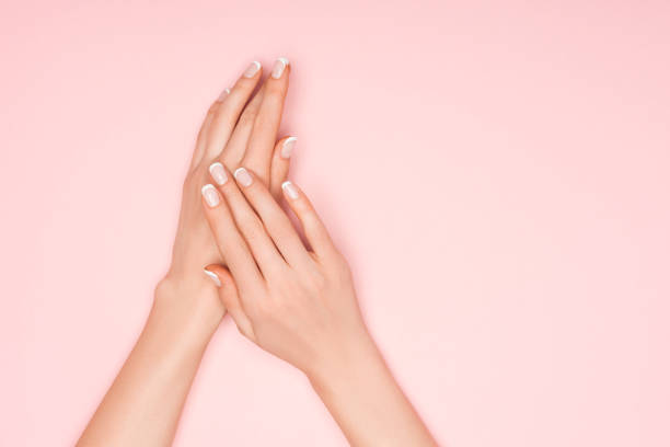 istock partial view of female hands isolated on pink with copy space 1092706778