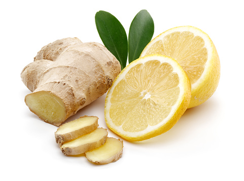 Fresh ginger and lemon with leaves isolated on white background