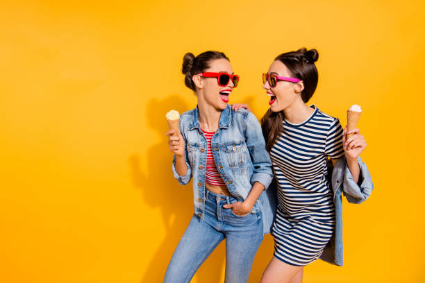 Photo of two brunette hair lady in glasses spectacles isolated on yellow background hold sugar tasty yummy delicious sweet appetiser snack in hands look each other make beaming hollywood toothy smile Photo of two brunette hair lady in glasses spectacles isolated on yellow background hold sugar tasty yummy delicious sweet appetiser snack in hands look each other make beaming hollywood toothy smile appetiser stock pictures, royalty-free photos & images